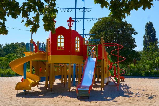istock Summer spring children's playground with painted toy slide in park 2150789496