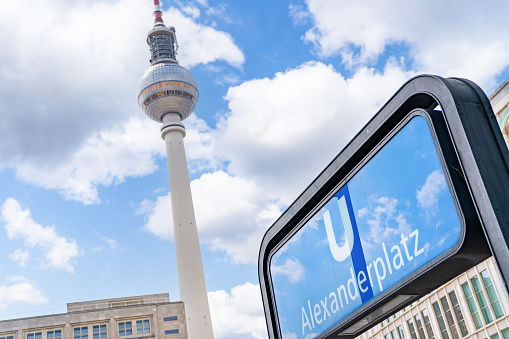 Berlin’s Iconic Alexanderplatz U-Bahn Sign with TV Tower Background.