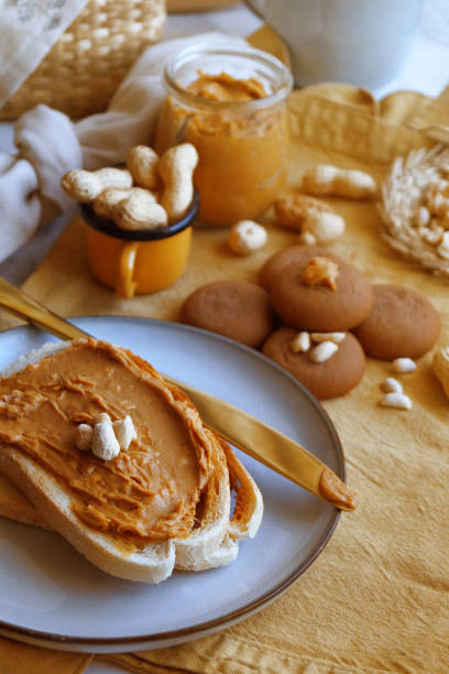 Fresh bread slices generously spread with rich peanut butter
