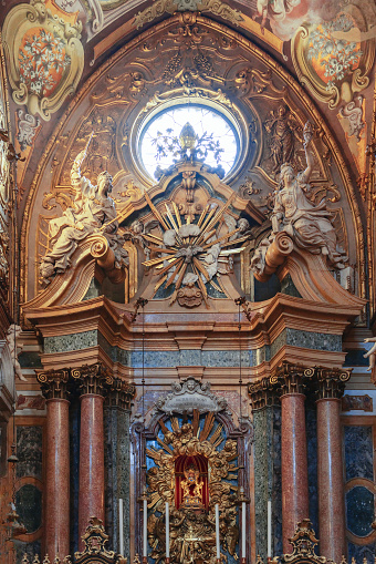 Bologna - Italy. February 11, 2023: Inside San Petronio Basilica, Bologna, the richly decorated altar stands as a testament to baroque opulence, framed by marble and gold
