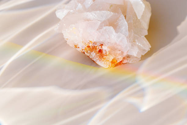 istock Quartz Prism's Rainbow Reflection at sunlight, close up of clear quartz crystal captures prismatic rainbow, natural facets and beauty of mineral. Minimal aesthetic nature pattern, beige pastel tone 2150795220