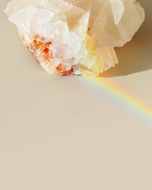 istock Luminous Quartz with Rainbow Flares. Sun's rays interact with quartz stone, iridescent rainbow glares, background with shining crystal at sunlight, aesthetic view with natural light effect 2150795289