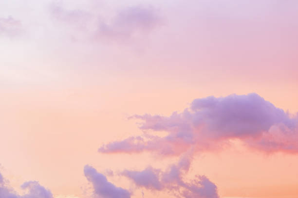 istock Pastel Sunset, violet fluffy clouds on pink peach colored sky, dreamy cloudscape pastel tones, surreal dreamscape at sunset, soft vivid colorful heaven as background, wallpaper, backdrop 2150795300