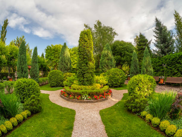 istock Summer garden courtyard. Bush lined path in park. 2150797486