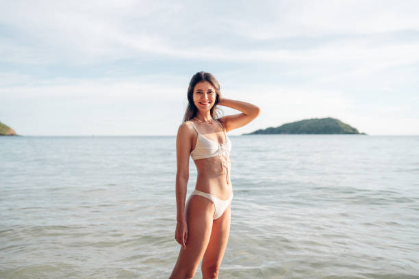 istock Woman in white bikini on tropical beach. 2150798226