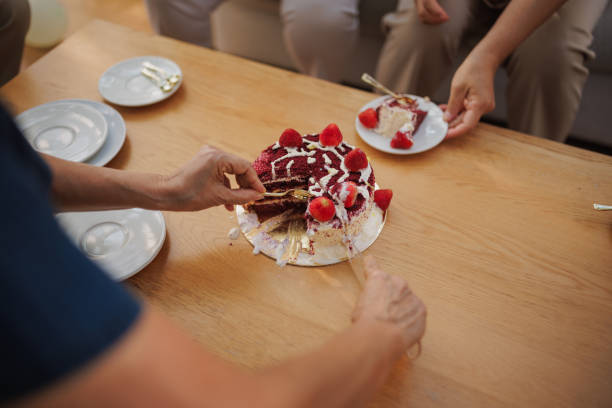 istock Senior woman serving birthday cake 2150798835