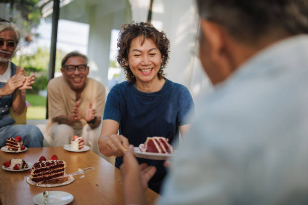 istock Senior woman serving birthday cake 2150800144