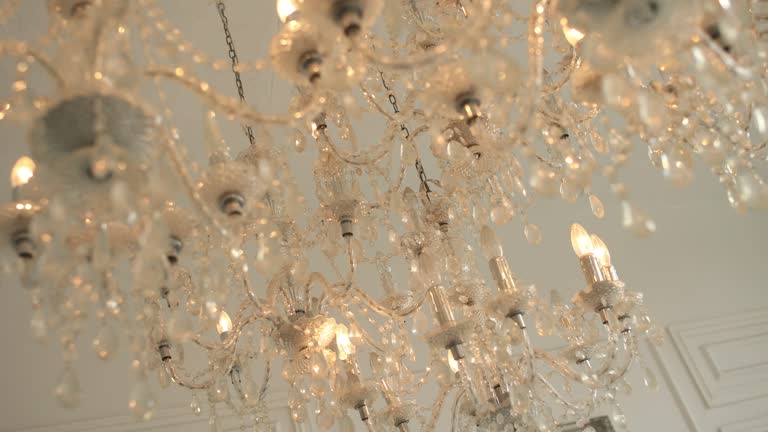 a large glass jewel chandelier on the ceiling in a hotel room