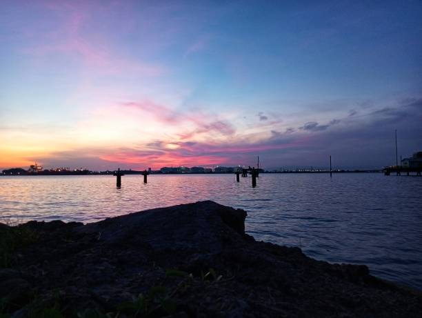 istock Silhouette island over the sea during sunrise 2150800868