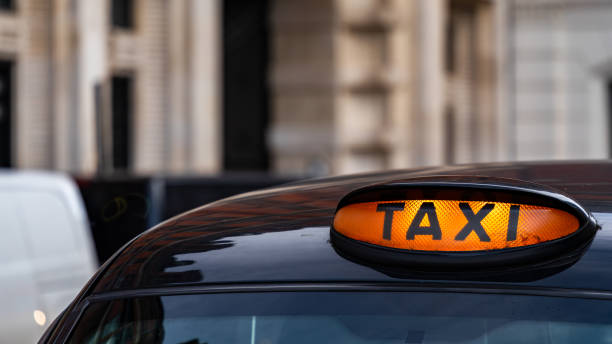 istock Taxi with it's sign on ready for hire 2150800911