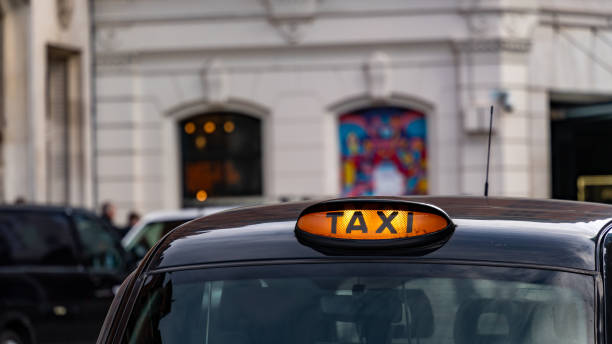 istock Taxi with it's sign on ready for hire 2150800945