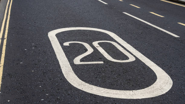 istock 20mph speed sign painted on asphalt 2150801064