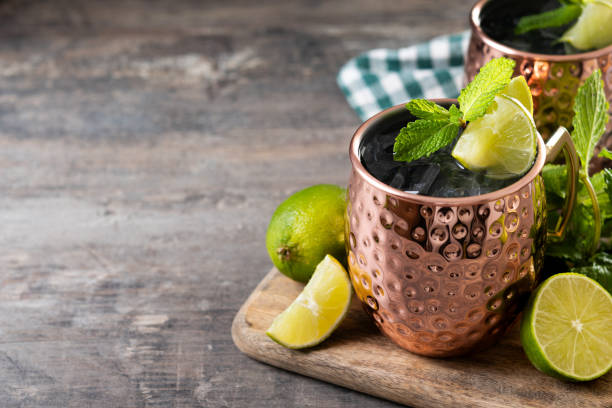 istock Moscow mule cocktail served with ice and lime slice on wooden table 2150801343