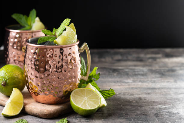istock Moscow mule cocktail served with ice and lime slice on wooden table 2150801513
