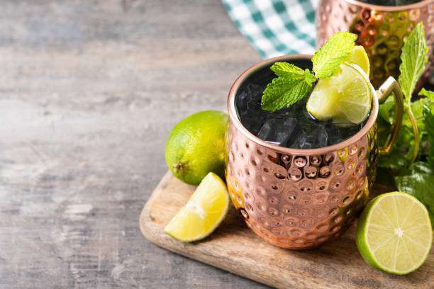 istock Moscow mule cocktail served with ice and lime slice on wooden table 2150801517