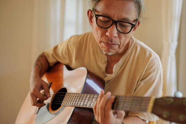 istock Senior man playing a guitar 2150801525