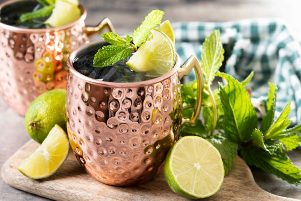 istock Moscow mule cocktail served with ice and lime slice on wooden table 2150801538