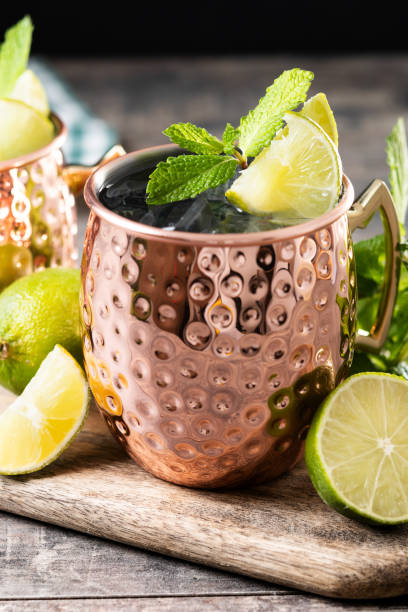 istock Moscow mule cocktail served with ice and lime slice on wooden table 2150801562