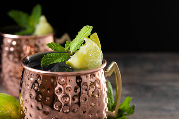 istock Moscow mule cocktail served with ice and lime slice on wooden table 2150801576