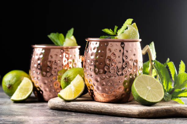 istock Moscow mule cocktail served with ice and lime slice on wooden table. 2150801582