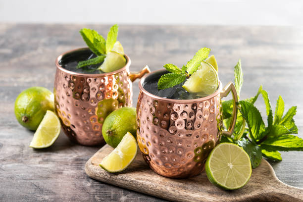 istock Moscow mule cocktail served with ice and lime slice on wooden table. 2150801588