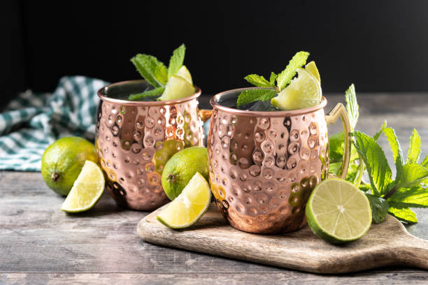 istock Moscow mule cocktail served with ice and lime slice on wooden table. 2150801591