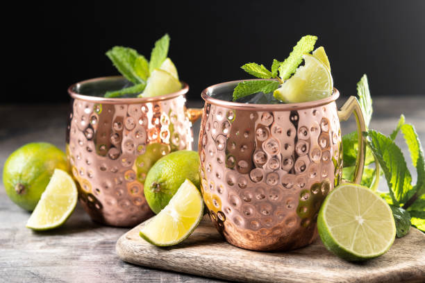 istock Moscow mule cocktail served with ice and lime slice on wooden table. 2150801605