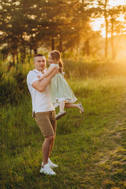 istock Happy father playing and carrying his daughter on shoulders. 2150801916