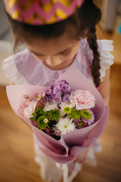 The lady holding colorful  bunch of flowers