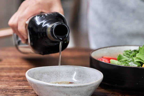 istock pouring olive oil to saucer 2150802309