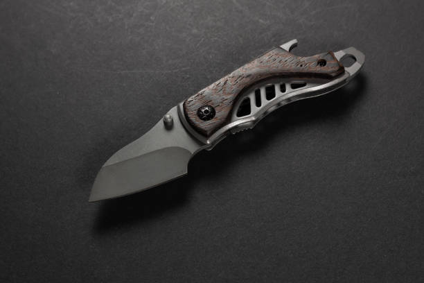 istock tactical folding knife. EDC knife. on dark background 2150802745