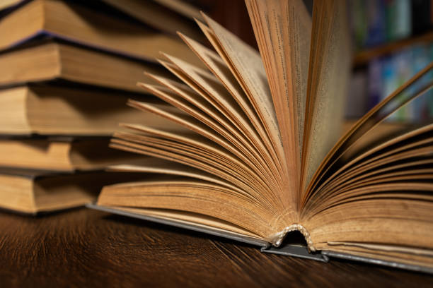 opened book, lying on the bookshelf in library.
