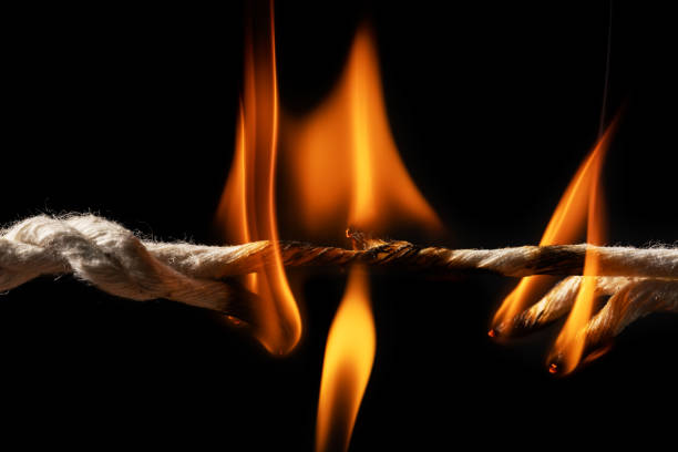 istock Burning rope at breaking point on black background, Risk concept 2150802804