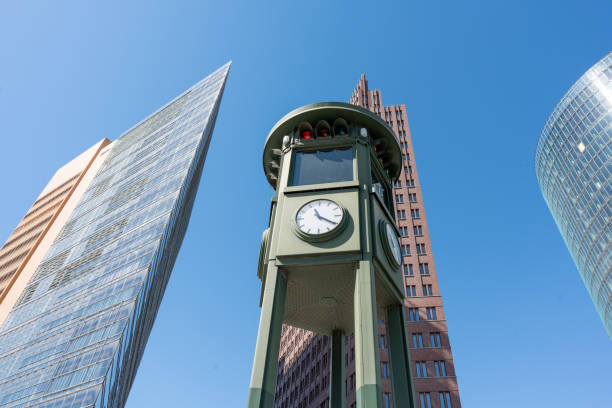 istock An old tower on which a clock and a traffic light are located against the backdrop of modern tall buildings. 2150804082