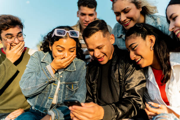 Friends talking and looking at photos on mobile phone