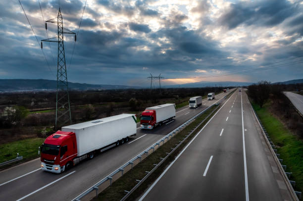 istock Convoy of red trucks with white containers 2150804320