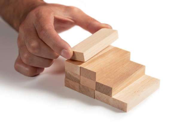 istock a business man build a blocks wood game 2150804372