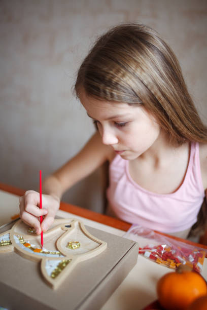istock A girl creates a fox from mosaics. 2150804769