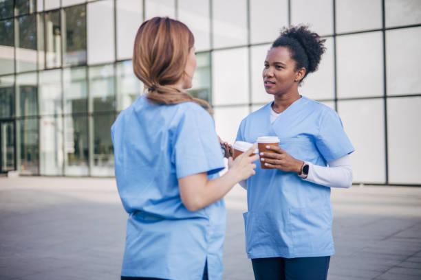istock Female doctors drink coffee during their break and talk. 2150805625