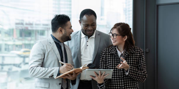 istock Happy diverse coworker discussing report on tablet, working on project together 2150805857