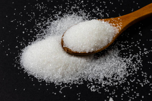 istock White sugar and wooden spoon 2150805886