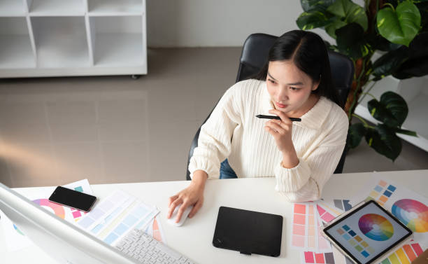 istock Top view of female designer working in graphic design using computer Sit and choose colors and work intently in your office. 2150807161