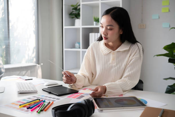 istock Female designer working in graphic design on computer Sit and choose colors and work intently in your office. 2150807194