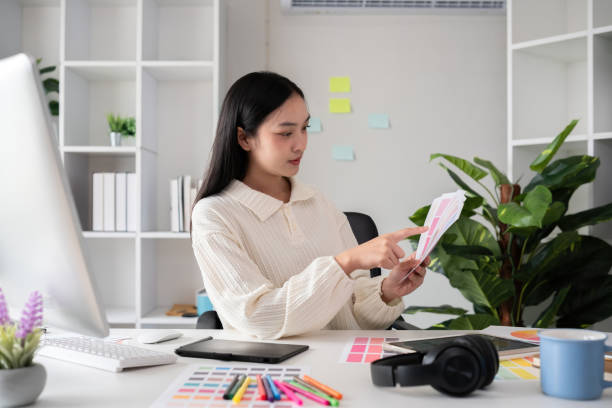 istock Female designer working in graphic design on computer Sit and choose colors and work intently in your office. 2150807201
