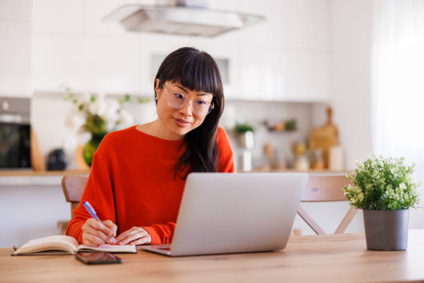 istock Mature woman taking online course at home using laptop computer 2150810093