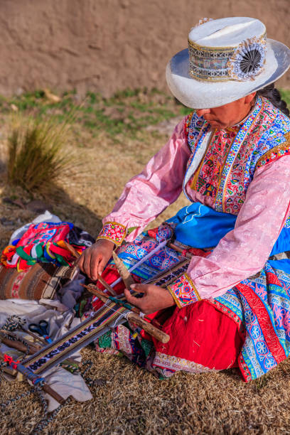 istock Peruvian woman weaving near Colca Canyon, Peru 2150811039