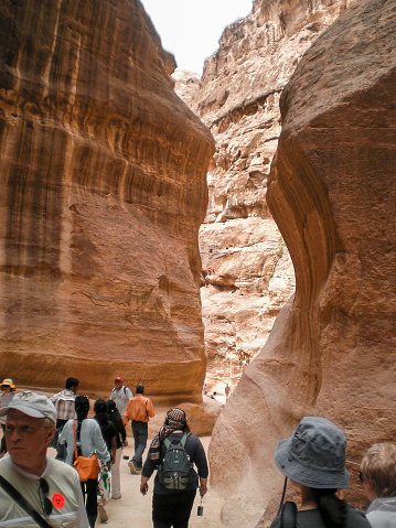 Wadi Musa, Jordan, April 18, 2008 : Tourists walk along Al Siq gorge of Historical Reserve of Petra near city of Wadi Musa which is home to Petra in Jordan