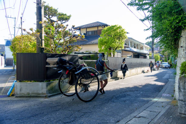 Kamakura, Kanagawa, Japan - April 25, 2024: Rickshaw going through the residential area around Kamakura Station