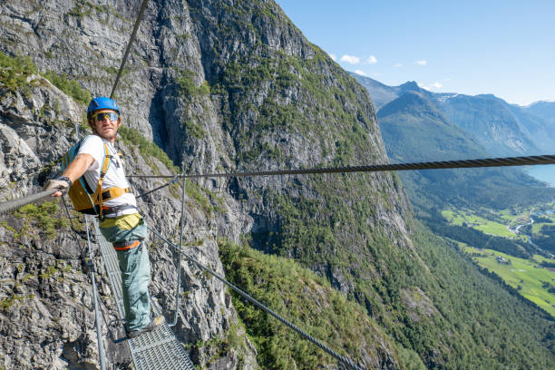 istock Climber on a High Mountain Trail Overlooking a Mountain Valley 2150817470