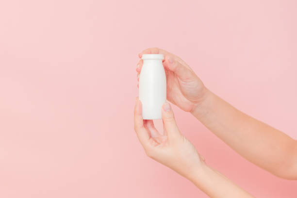 istock Hand holding bottle of probiotic yogurt for digestive system. Dietary supplements for stomach 2150818377
